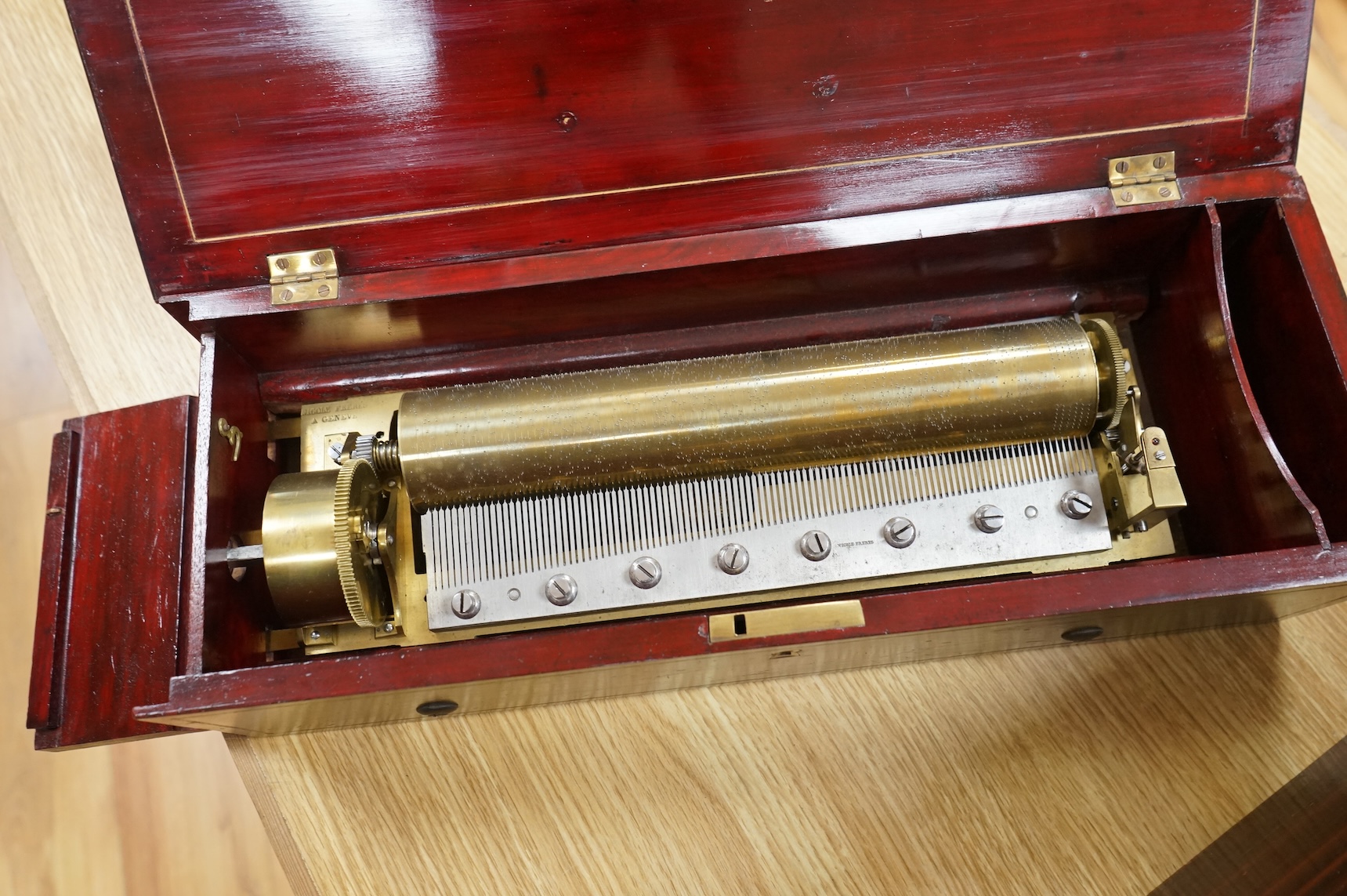 A mid 19th century Nicole Freres key wound cylinder musical box in an inlaid rosewood case, playing on approx 105 tooth comb, cylinder 27.5cm long, stamped ‘Nicole Frere a Geneve’, 26927, with key, the case; 45.5cm wide,